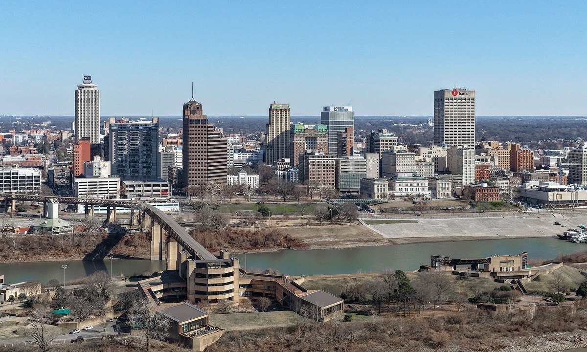 The downtown Memphis skyline photographed across the Mississippi River on a clear winter day, with the Hernando de Soto bridge in the foreground