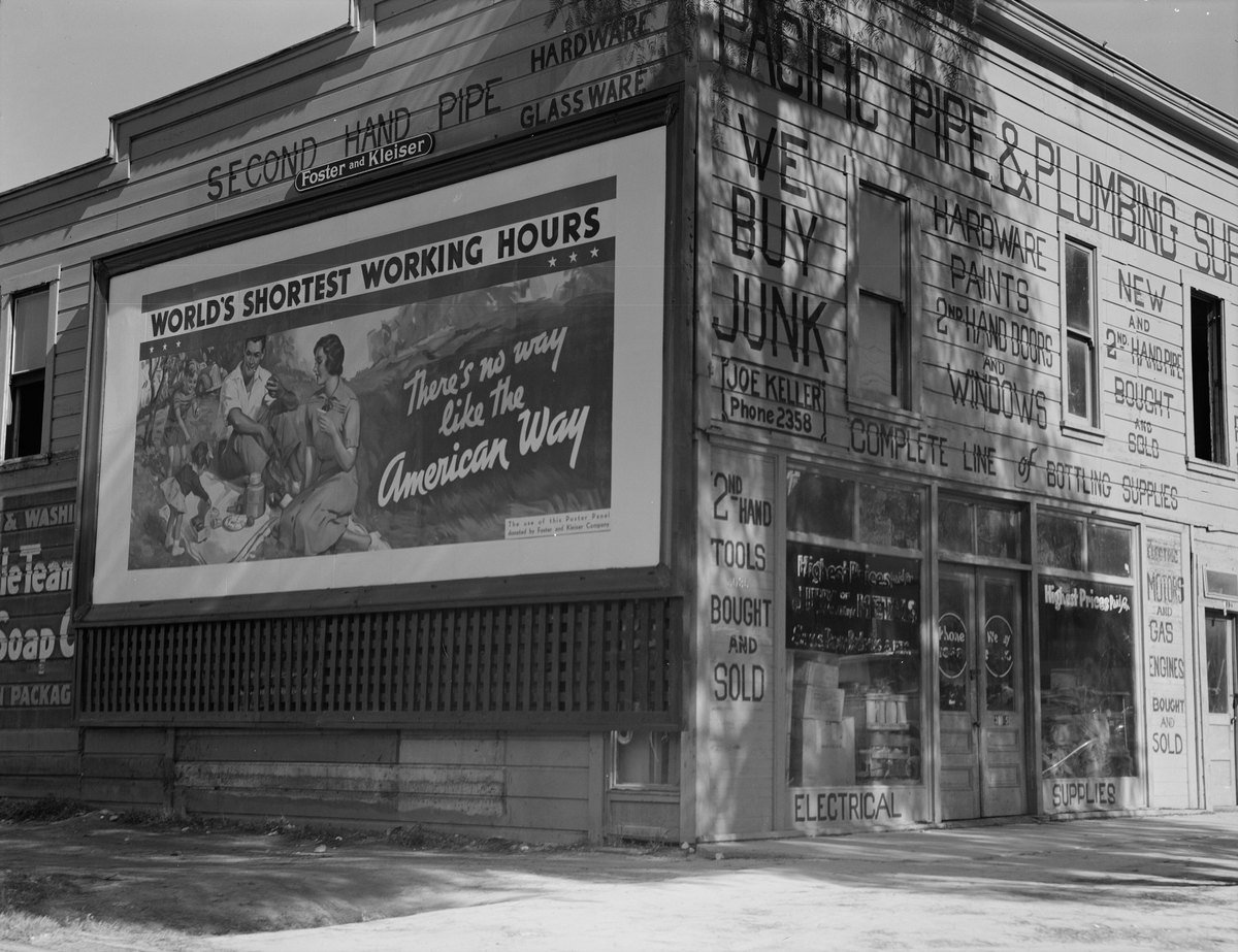A 1937 Dorothea Lange photograph of a California store building with every wall surface covered in painted advertising
