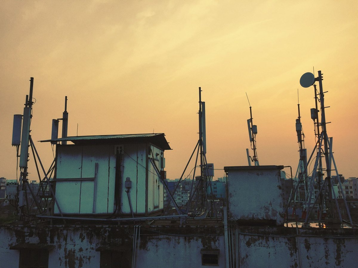 Rooftop cellular base station antennas at sunset
