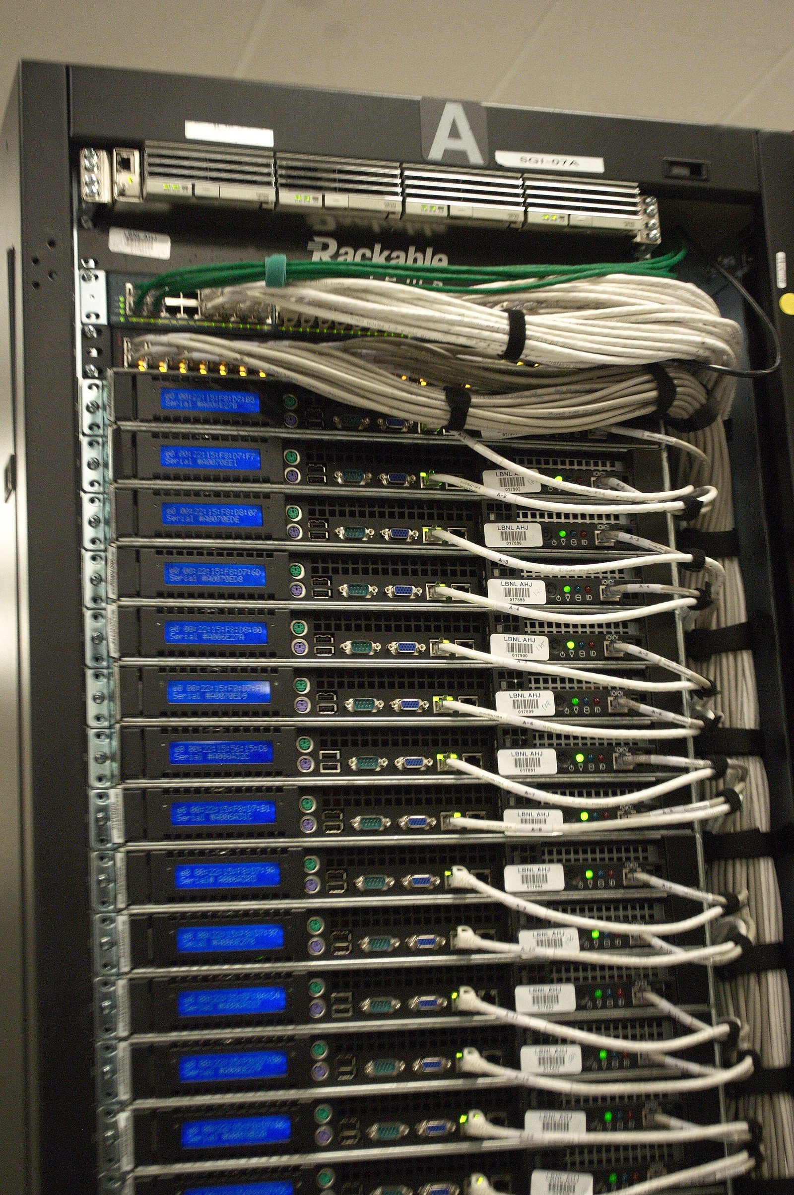 The rear of a server rack in a data center, dense with cabling