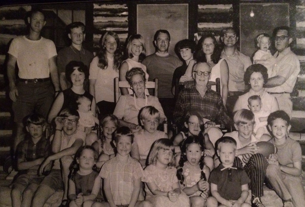 A 1970 extended family group portrait with twenty-seven people, taken at a state park cabin