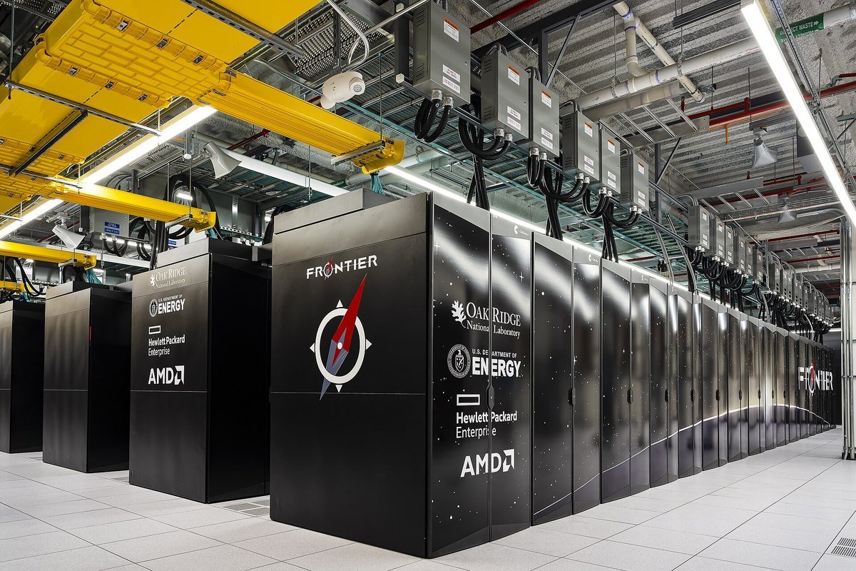 Rows of black Frontier supercomputer cabinets with Oak Ridge National Laboratory, Department of Energy, HPE and AMD logos