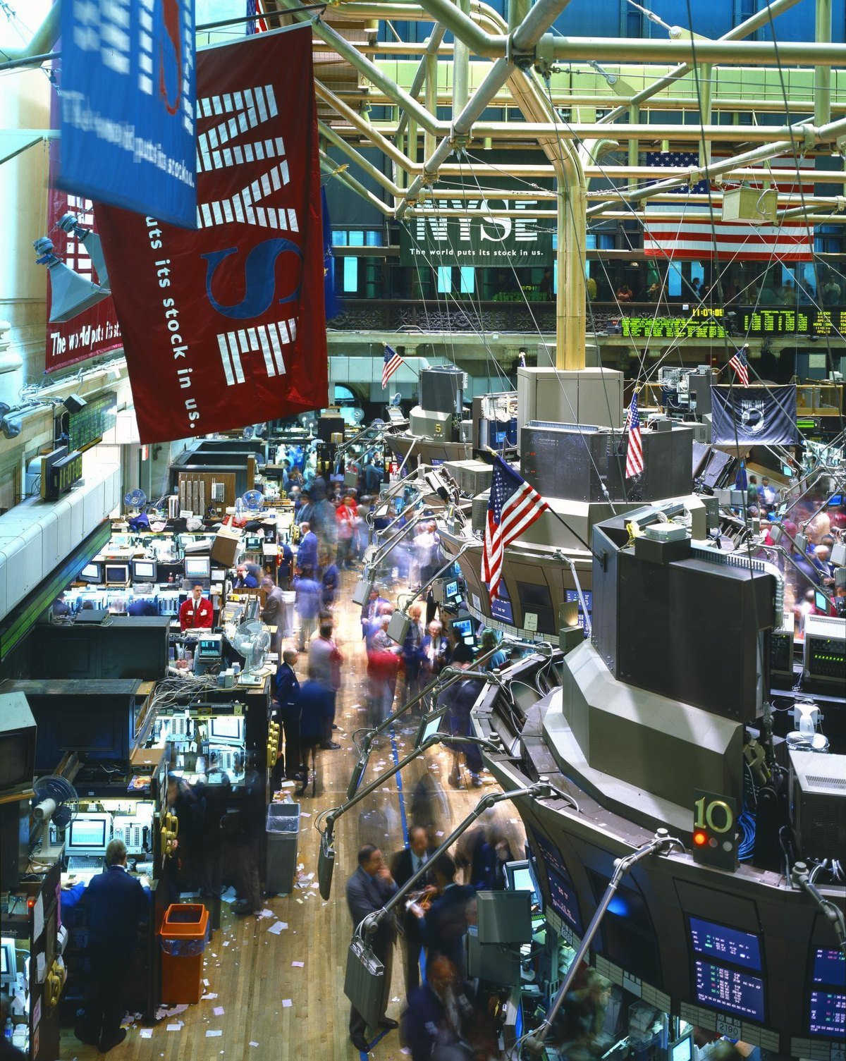 The trading floor of the New York Stock Exchange, with a banner reading The world puts its stock in us