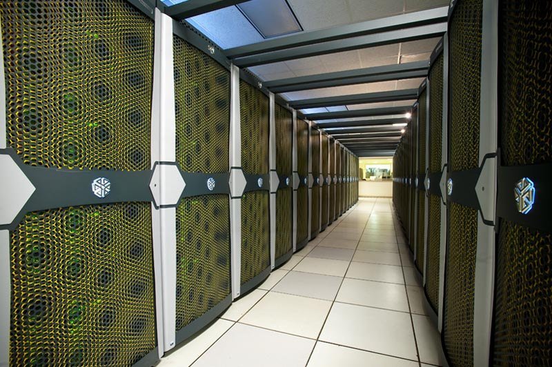 An aisle between two rows of supercomputer racks at a federal facility