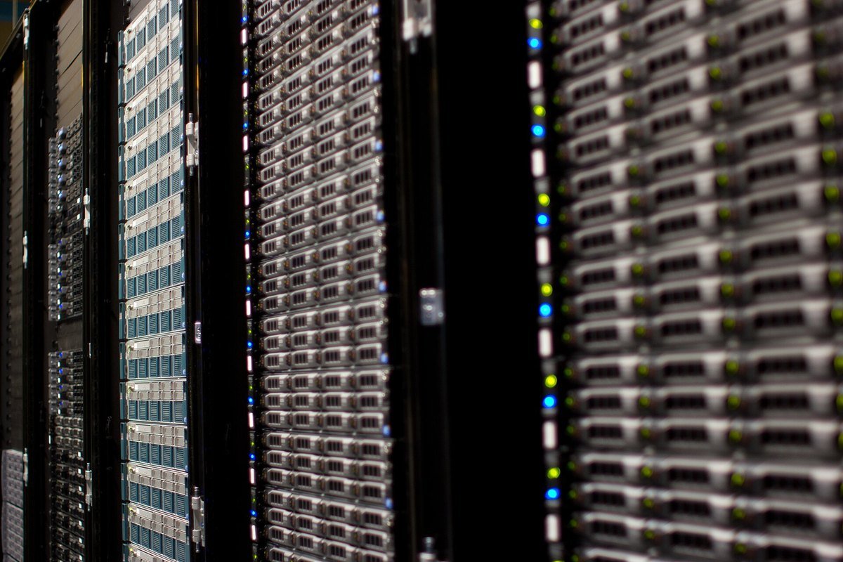 Rows of server racks with status lights in a data center