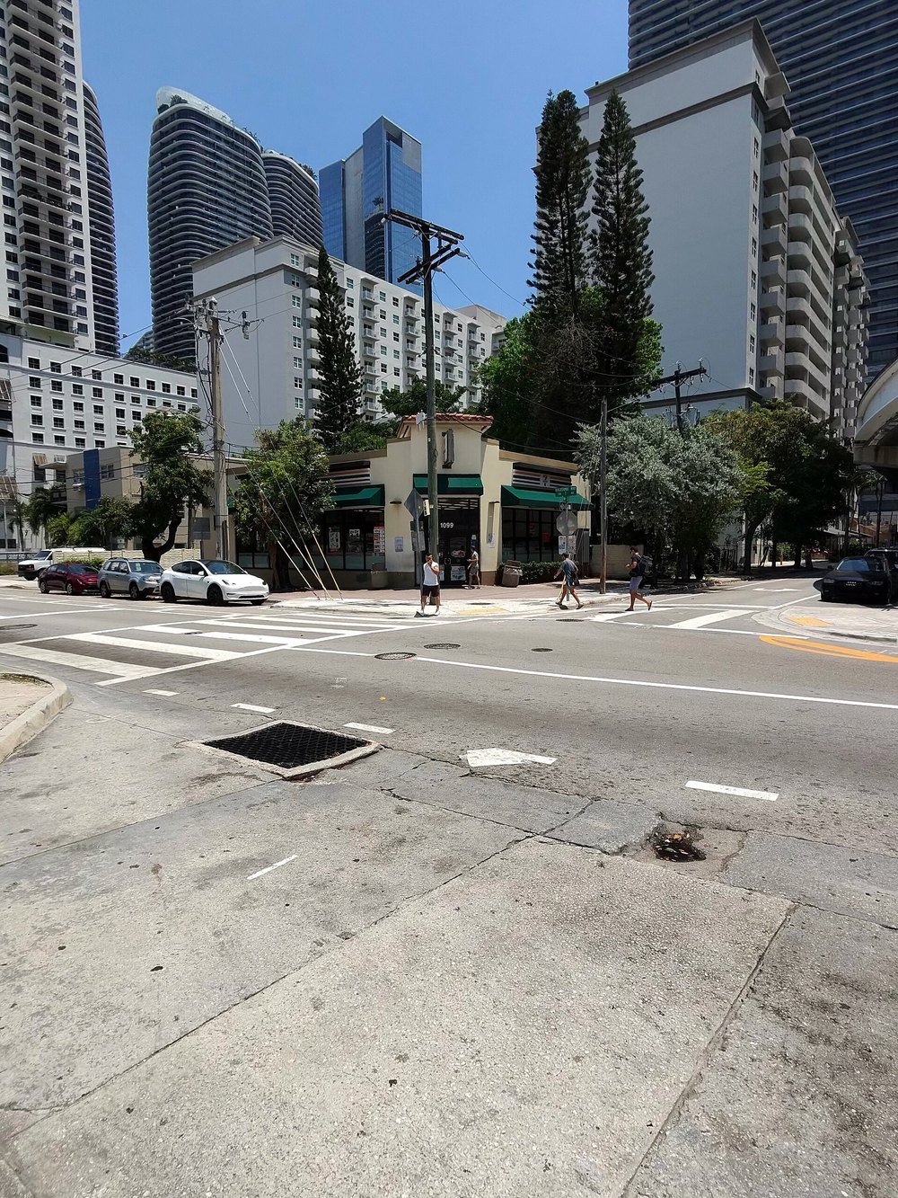 A Miami street corner photographed with Ray-Ban Meta smart glasses, showing pedestrians crossing