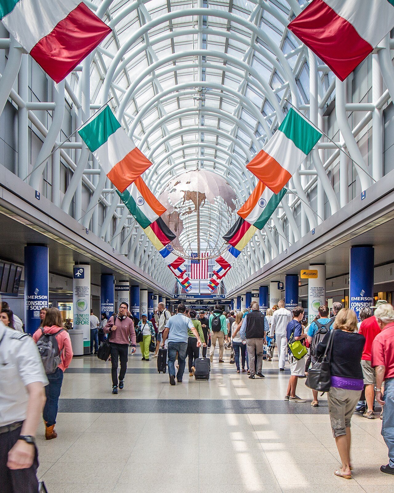 Travellers walking through an airport terminal concourse
