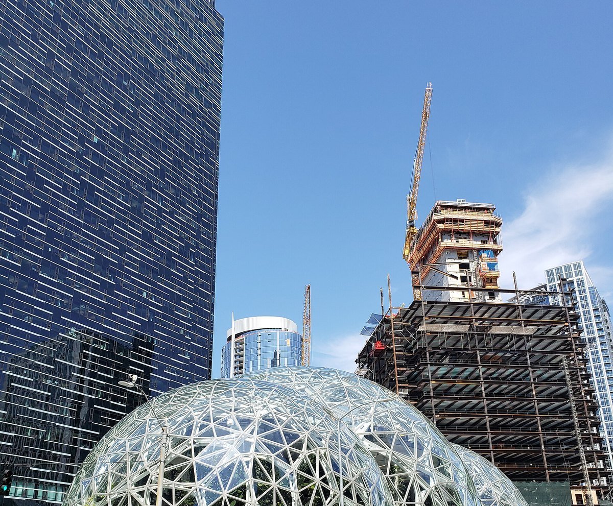 The glass Amazon Spheres in downtown Seattle on a clear day, with office towers behind them
