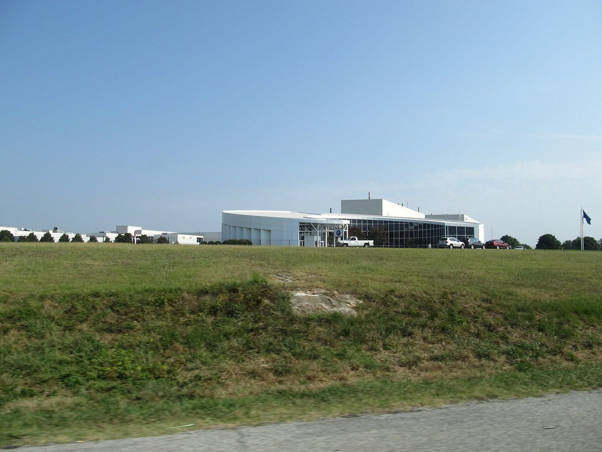 BMW manufacturing plant building in Greer, South Carolina, behind a grass field