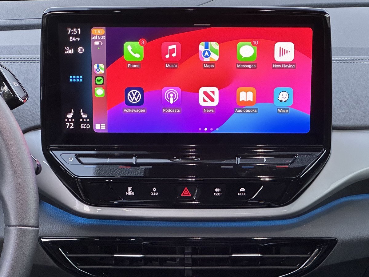 A car dashboard touchscreen showing Apple CarPlay app icons.