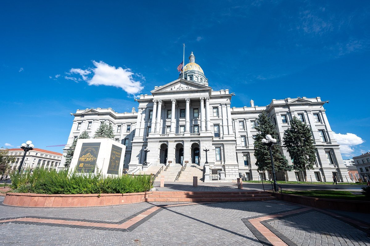 The Colorado State Capitol in Denver with its gold dome, seen from the west plaza on a clear day