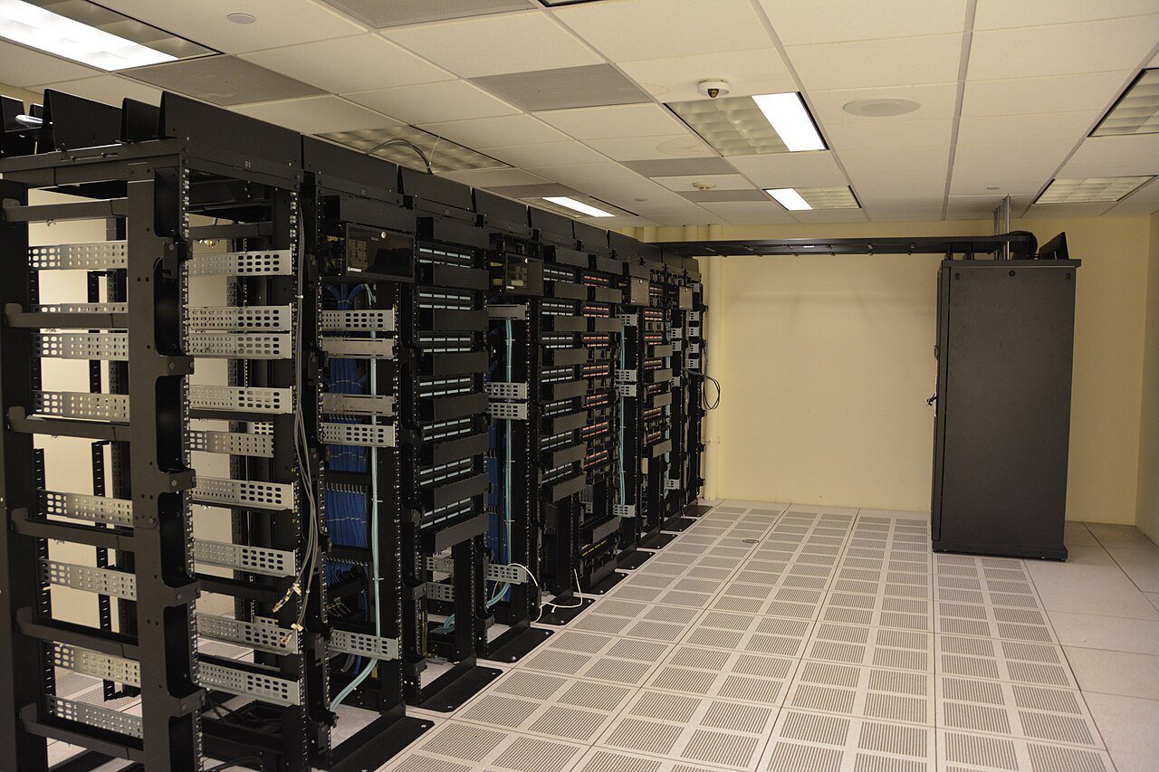 Rows of server racks and cabling in a data center room
