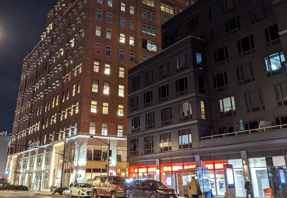 Google's building in Chelsea, Manhattan, at night, with the Google sign lit at street level