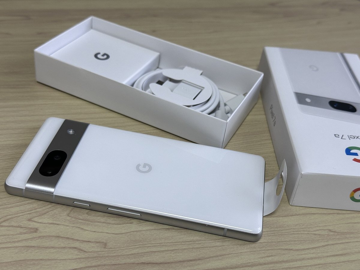 A Google Pixel 7a phone next to its box
