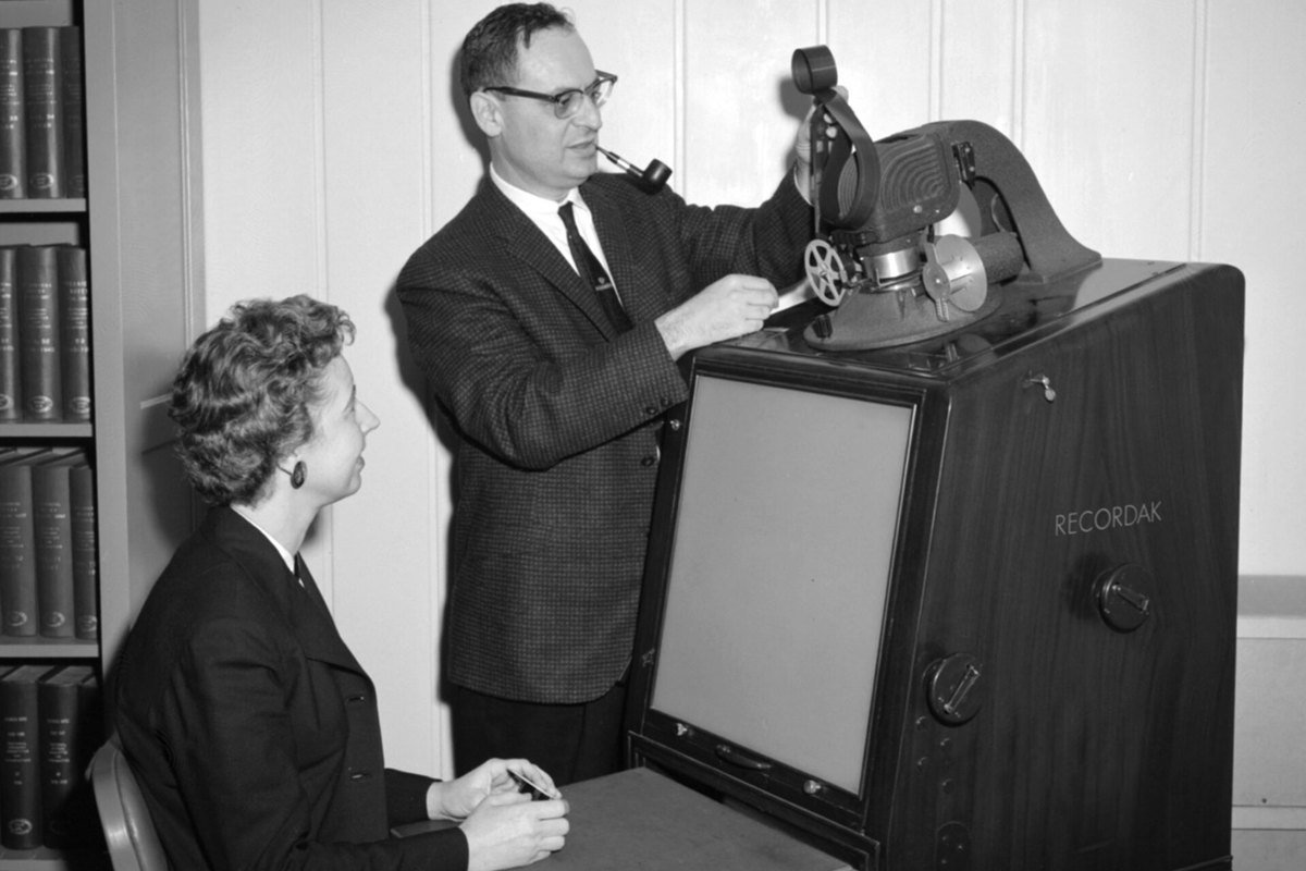 Two library staff members operate a Kodak Recordak microfilm reader at NASA's Lewis Research Center in 1961
