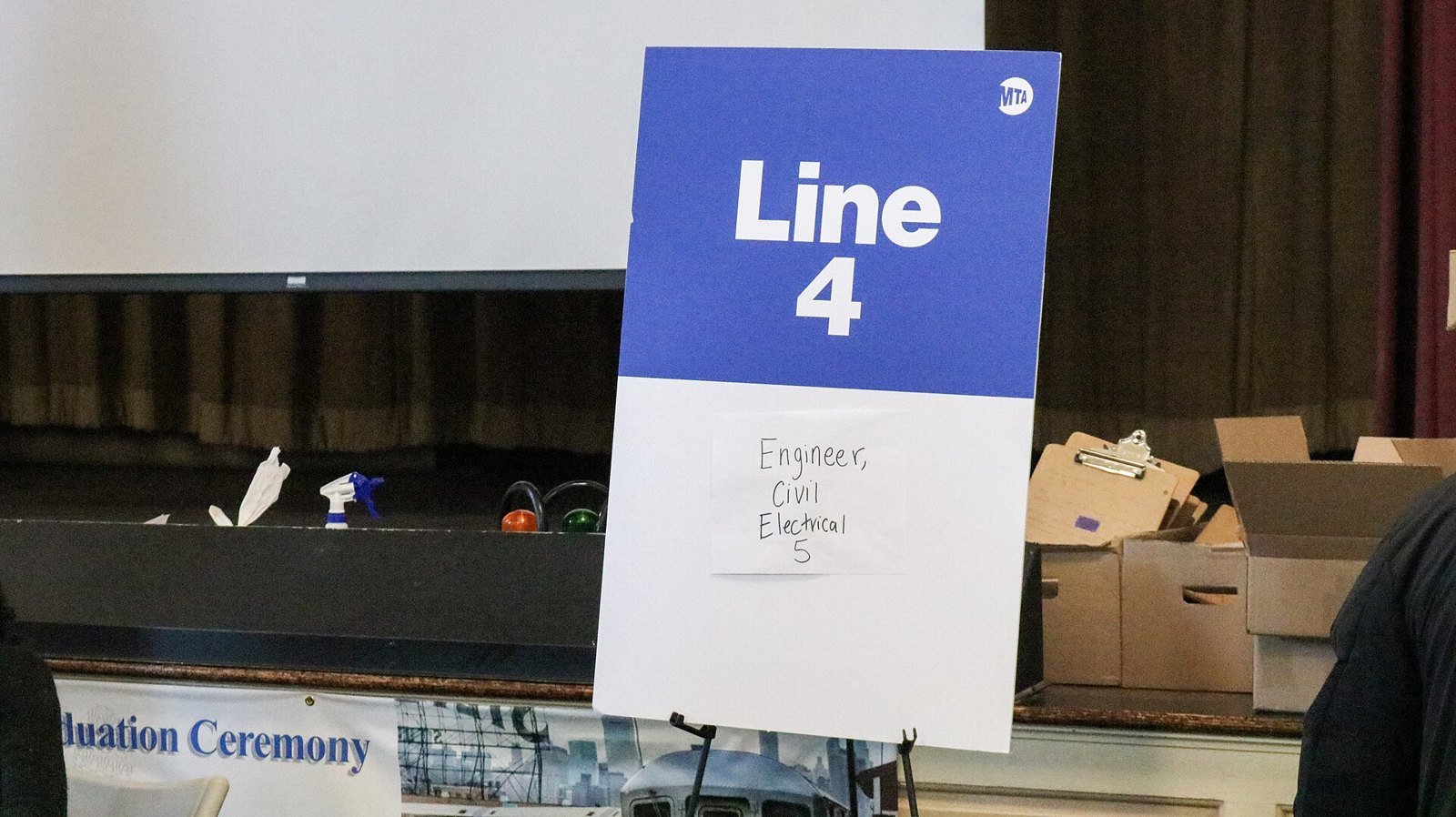 A sign at a New York City Transit job fair reading Line 4, with a handwritten note: Engineer, Civil, Electrical