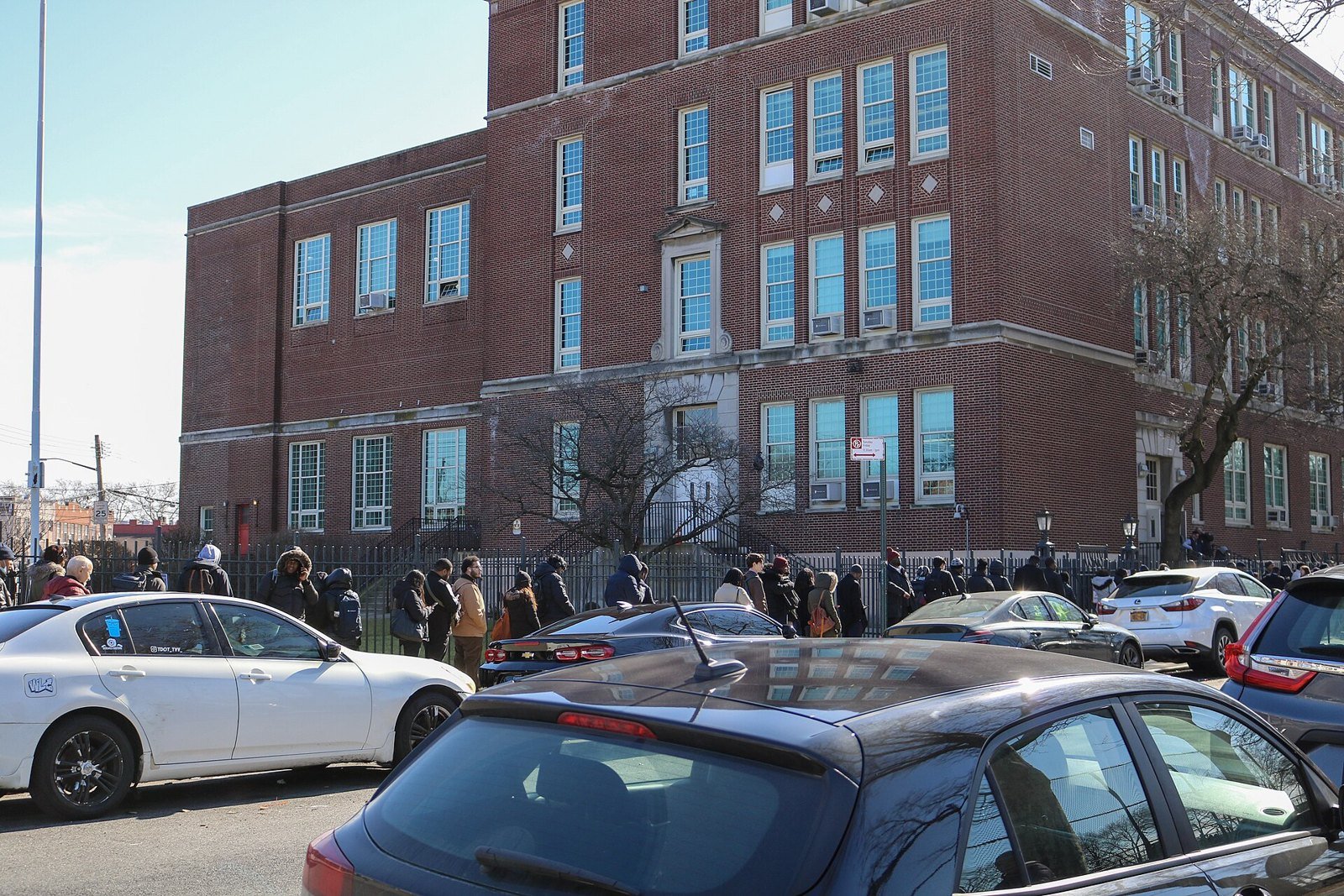 A crowd of job seekers gathered outside a brick building in New York City for a transit job fair