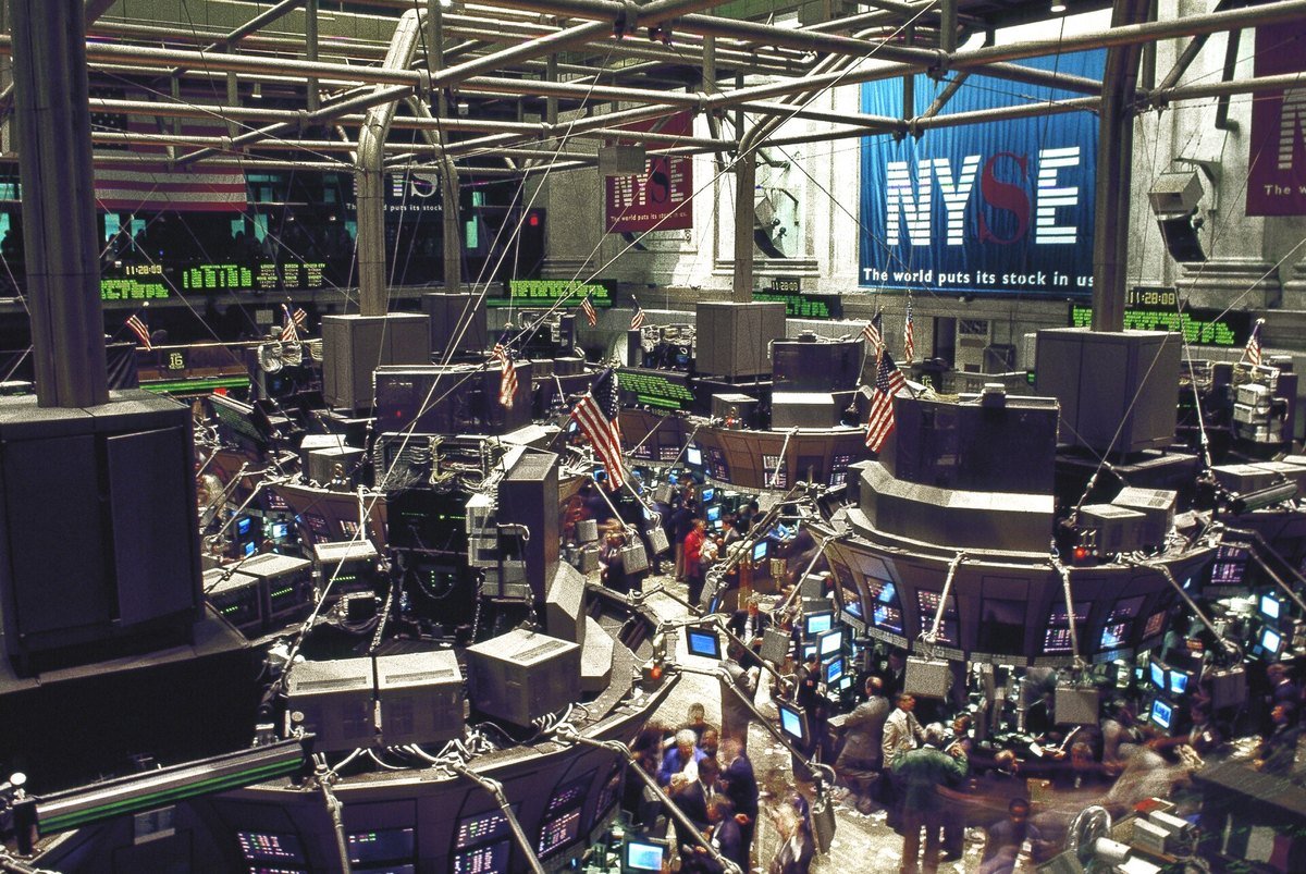 The trading floor of the New York Stock Exchange, with NYSE signage and banks of monitors