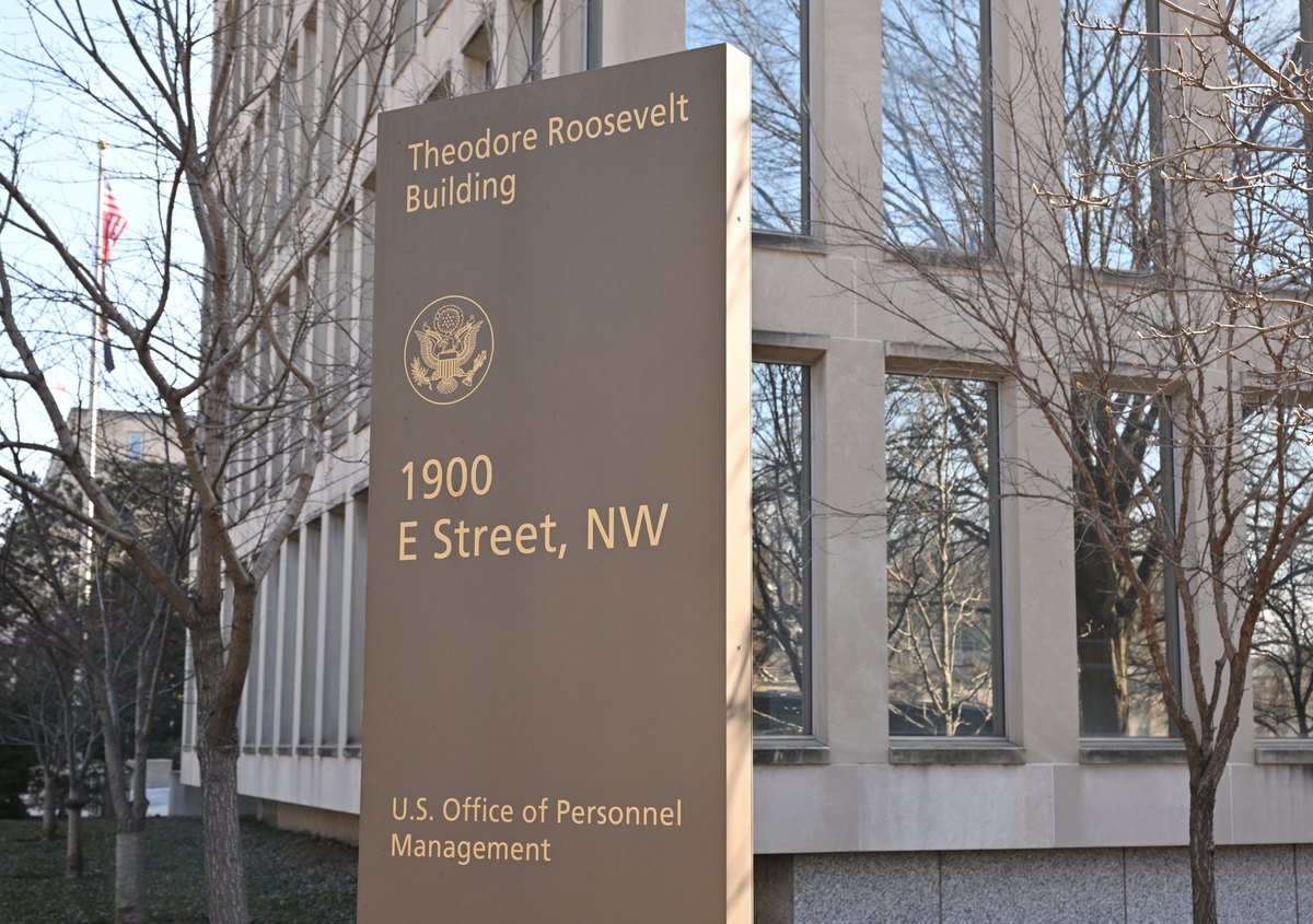 Sign outside the Theodore Roosevelt Building at 1900 E Street NW reading U.S. Office of Personnel Management
