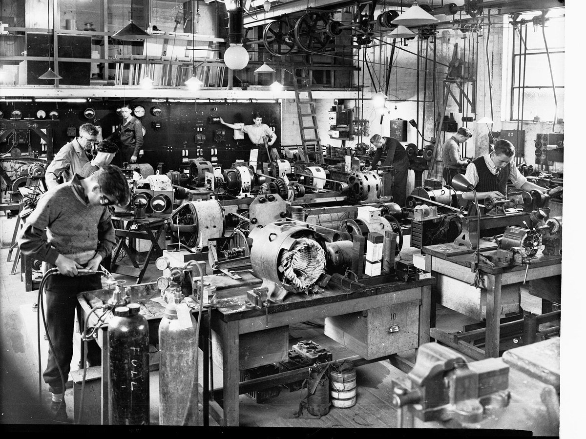 Students working on electrical machines in a trades school workshop