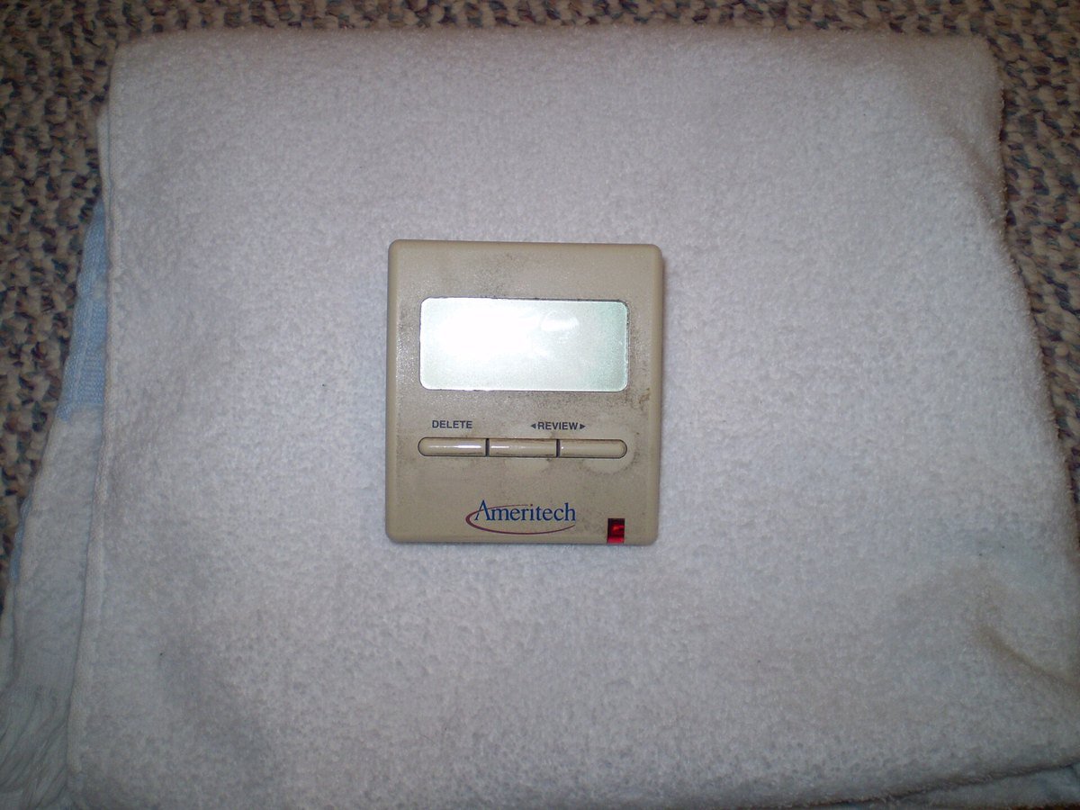 A small beige Ameritech caller ID box with a gray display screen and two buttons