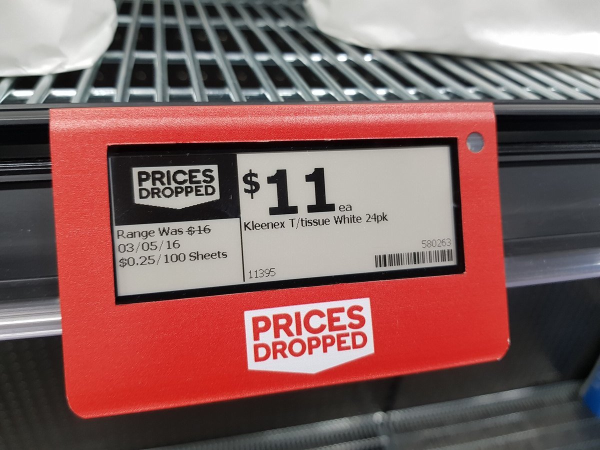 An electronic e-ink shelf price tag reading 11 dollars on a supermarket shelf