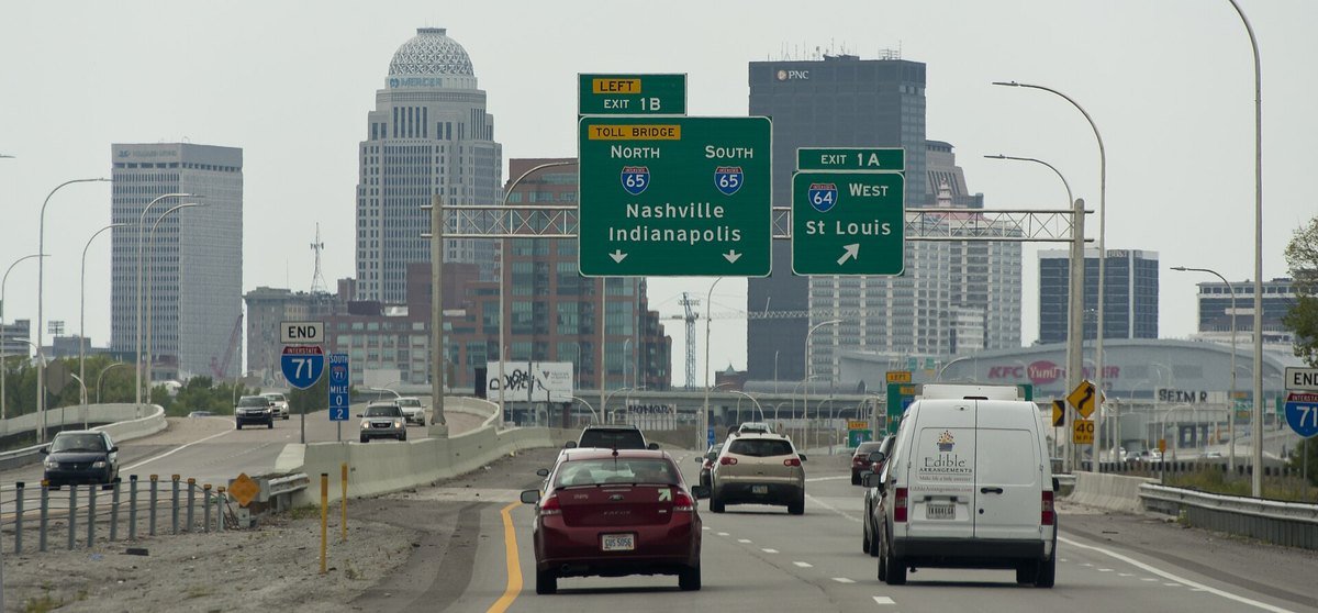 Interstate 71 ending in downtown Louisville, Kentucky, with green overhead signs for Interstate 65 and Interstate 64 exits