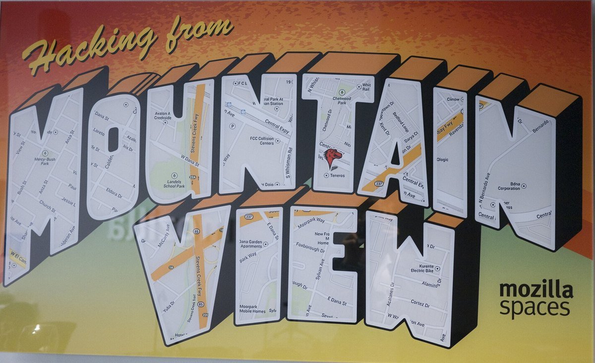 A large wall graphic reading Hacking from Mountain View, mozilla spaces, inside a Mozilla office