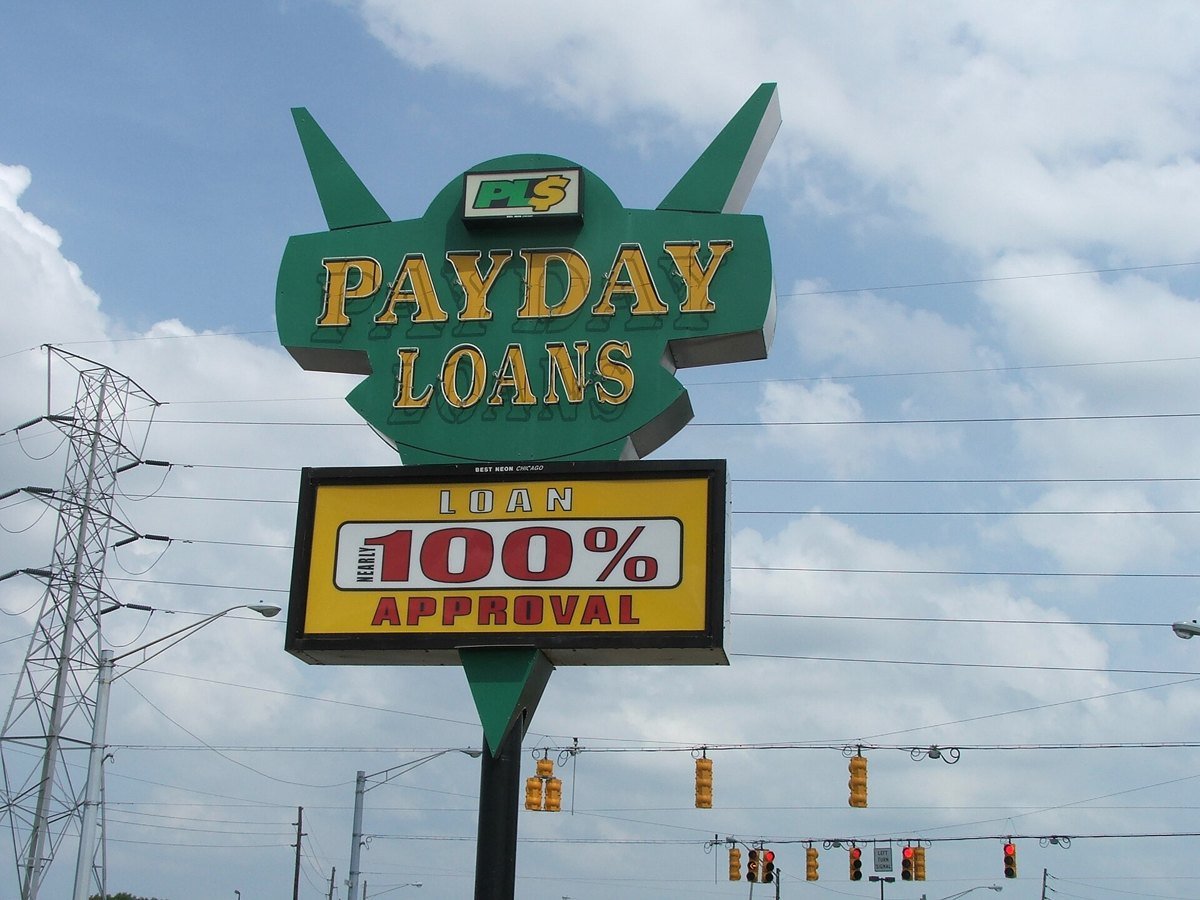 A roadside sign in Indianapolis reading Payday Loans, Loan nearly 100 percent approval
